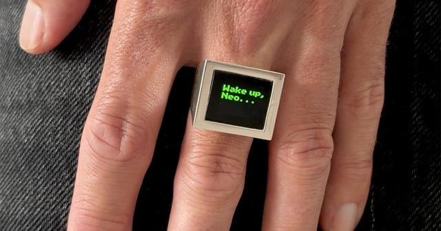 Miniature OLED display loops the matrix’s cascading green code inside a signet ring